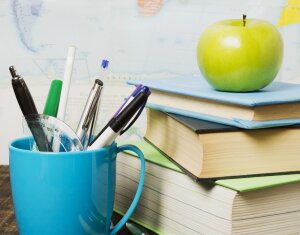front-view-desk-with-school-supplies-apple